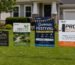 Different yard sign sizes and materials displayed for custom outdoor advertising.